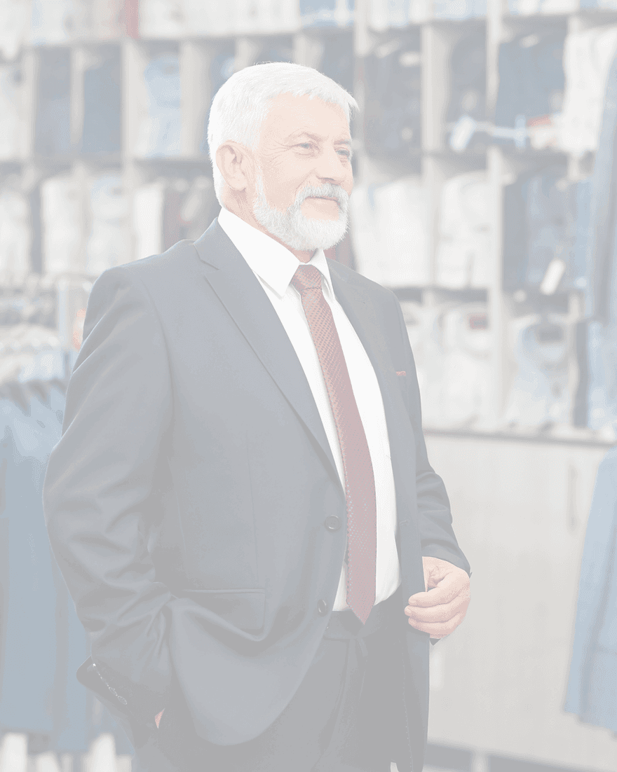 A senior retail leader on the shop floor of a menswear store