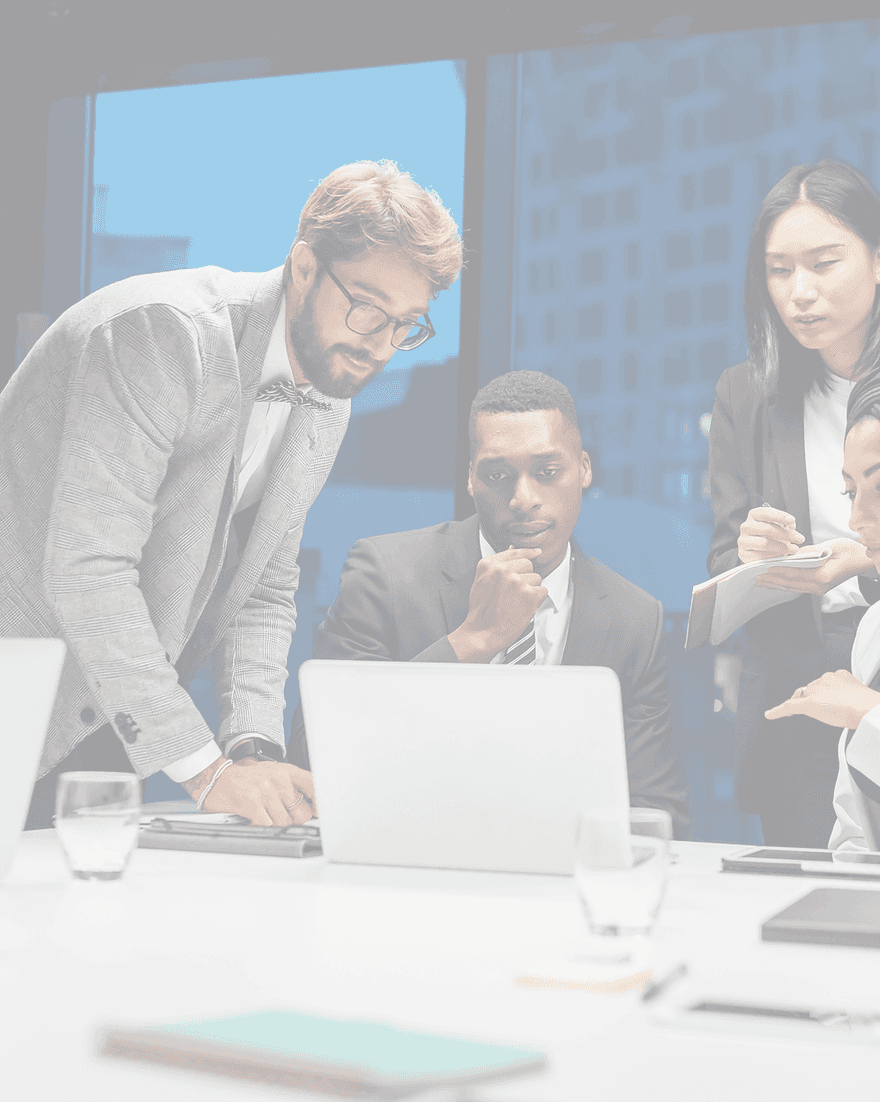Business professionals collaborating around a laptop in a modern office